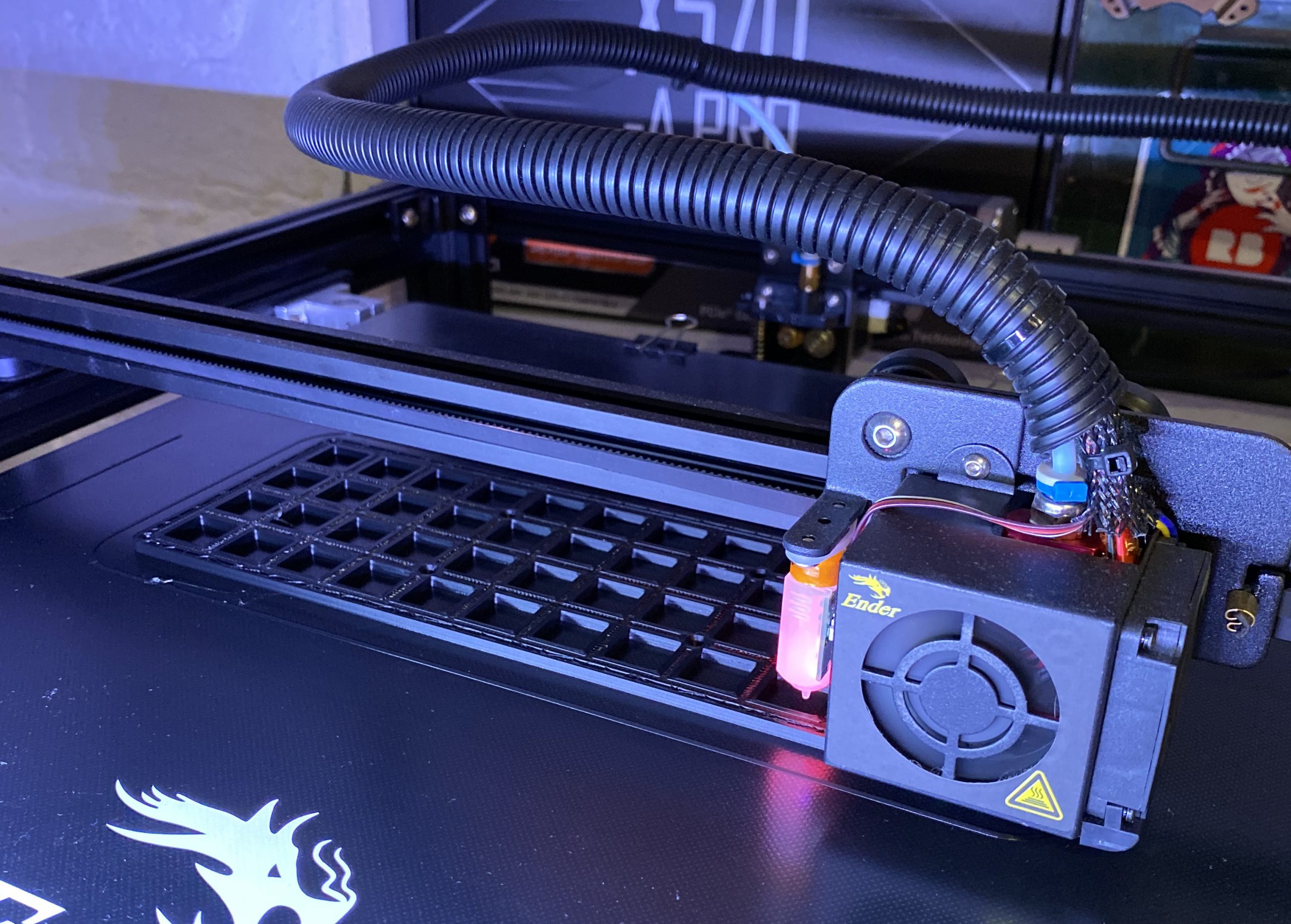 A 3D printer, printing a keyboard case in black PLA, the printer is an ender 5+.