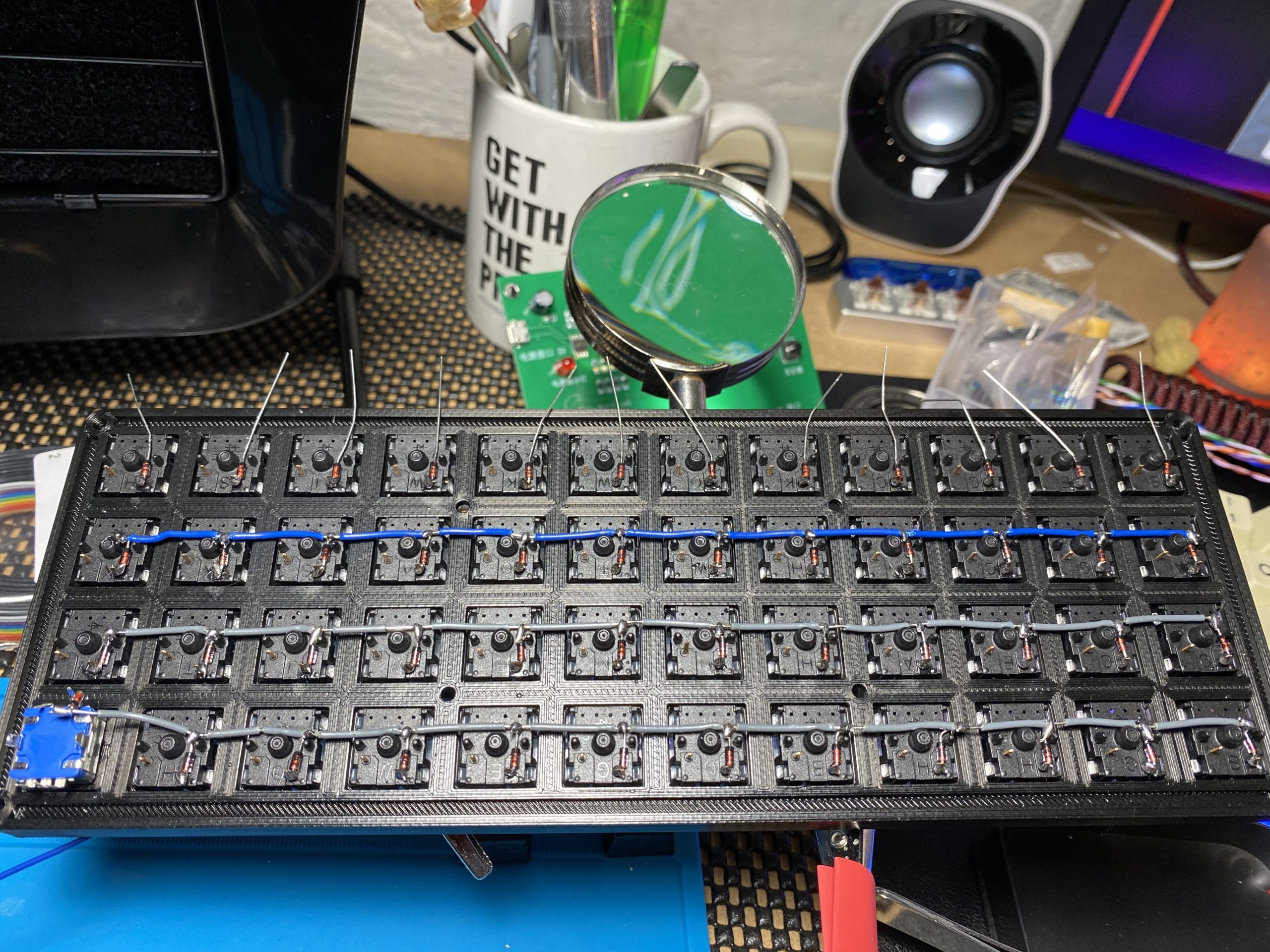 The previous picture of the keyboard has now moved forward in the build, wires are now starting to cross between the switches along the rows, joining up each of the diodes, three rows are done and one is left to wire.