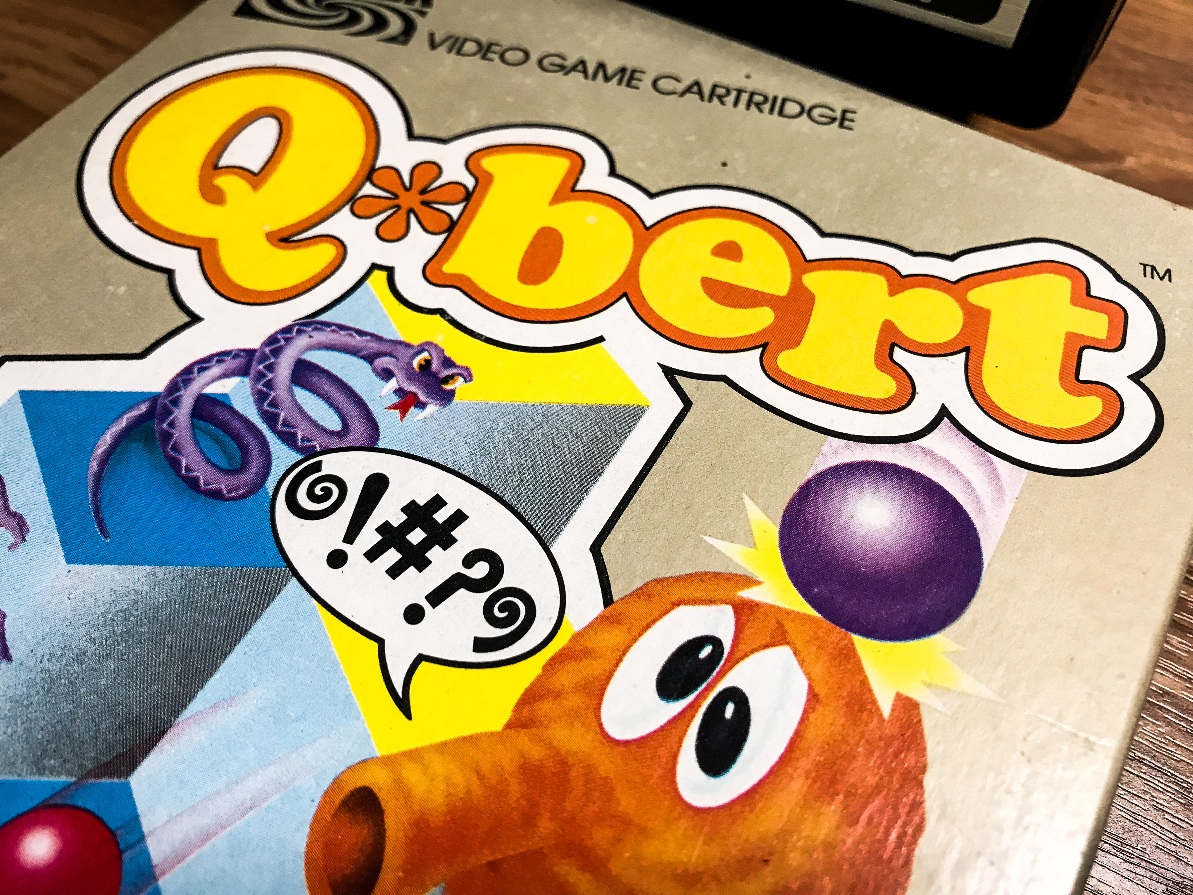 A close up shot of the box for a ColecoVision version of the game Q-Bert.