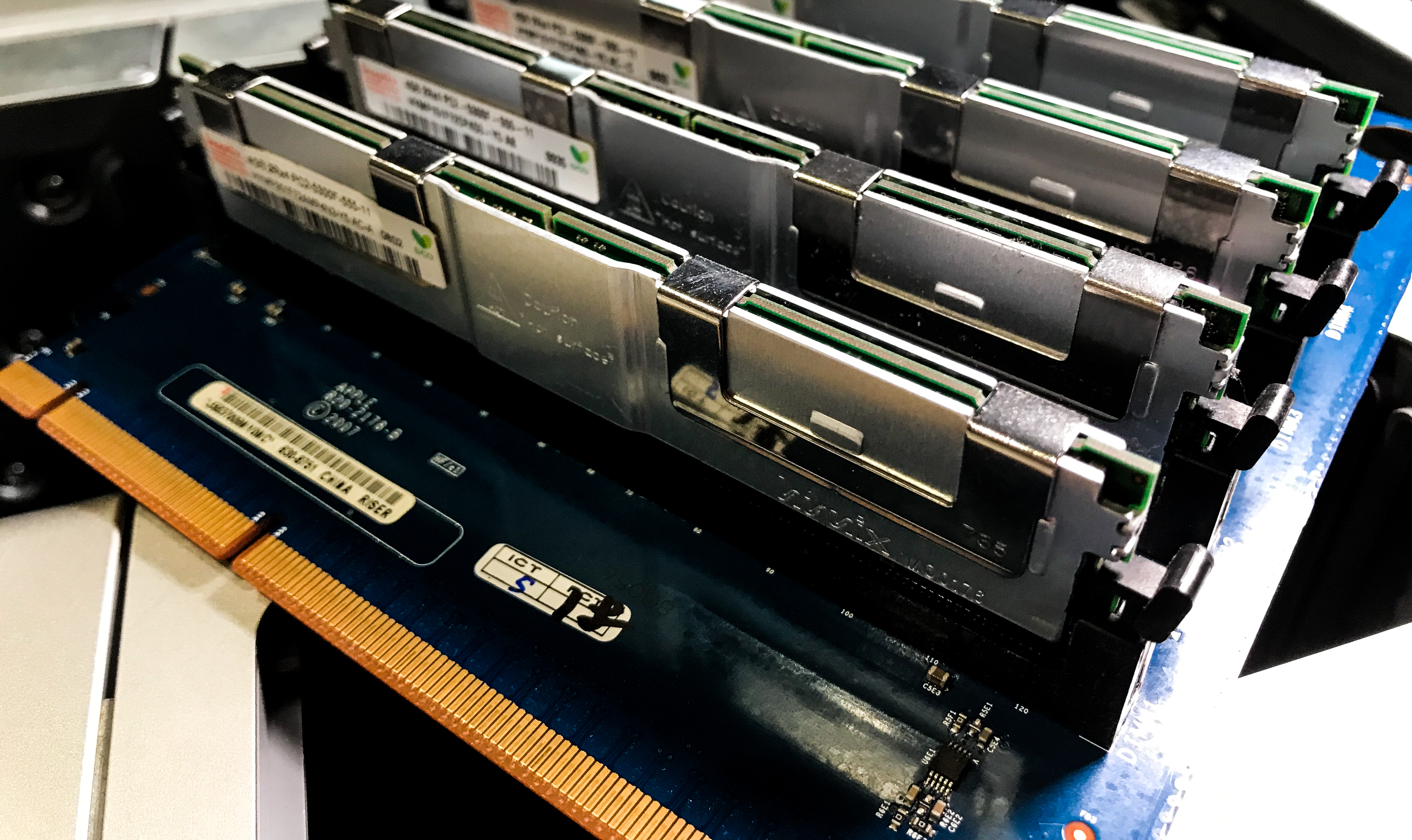 A MacPro 2008 ram card that is fully populated, sitting on a desk.